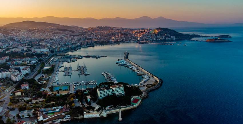 Kusadasi at sunset with its marina, breakwater and the causeway to Pigeon Island